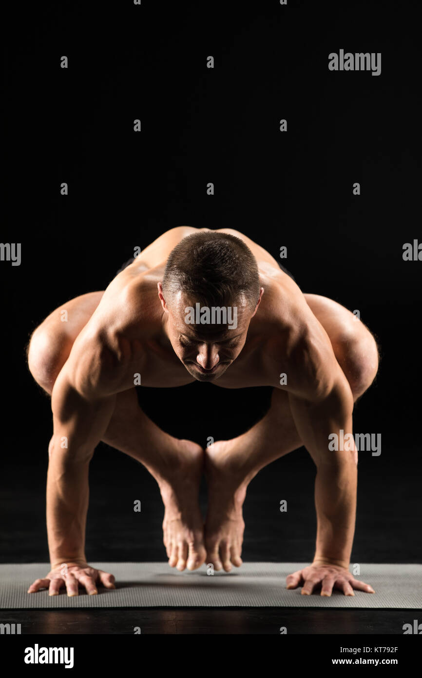 Uomo in piedi in posizione di yoga Foto Stock