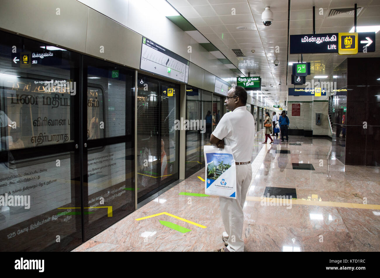 Uomo in attesa di treno nelle piattaforme della metropolitana di Chennai Foto Stock