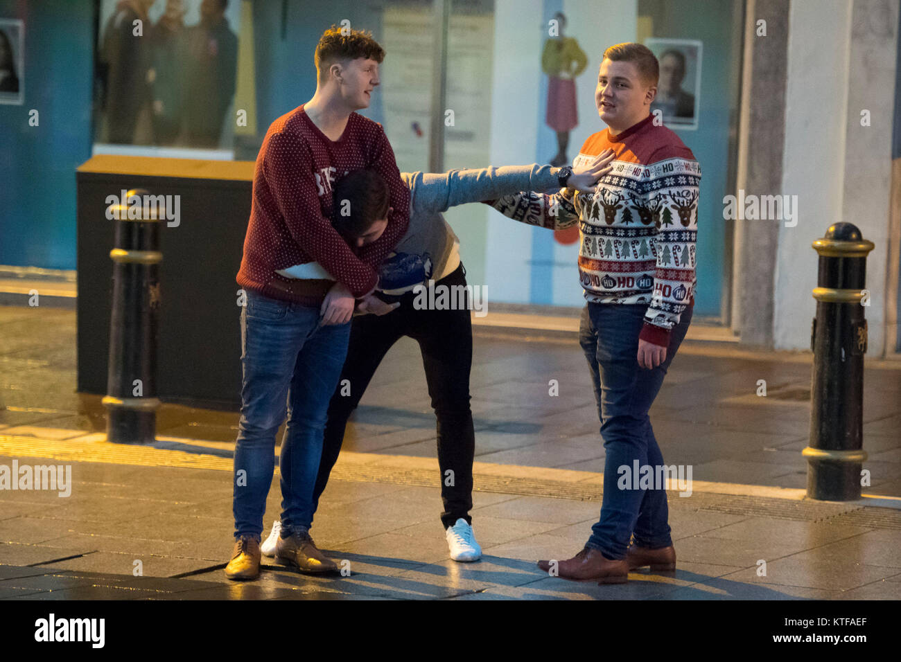 Mad venerdì festaioli fuori a Cardiff, nel Galles, per venerdì nero. Venerdì nero, l'ultimo venerdì prima di Natale, è tradizionalmente una delle notti più trafficato dell'anno per i servizi di emergenza. Un uomo ha un altro uomo in una headlock su St Mary Street, Cardiff. © GALLES NEWS SERVICE Foto Stock