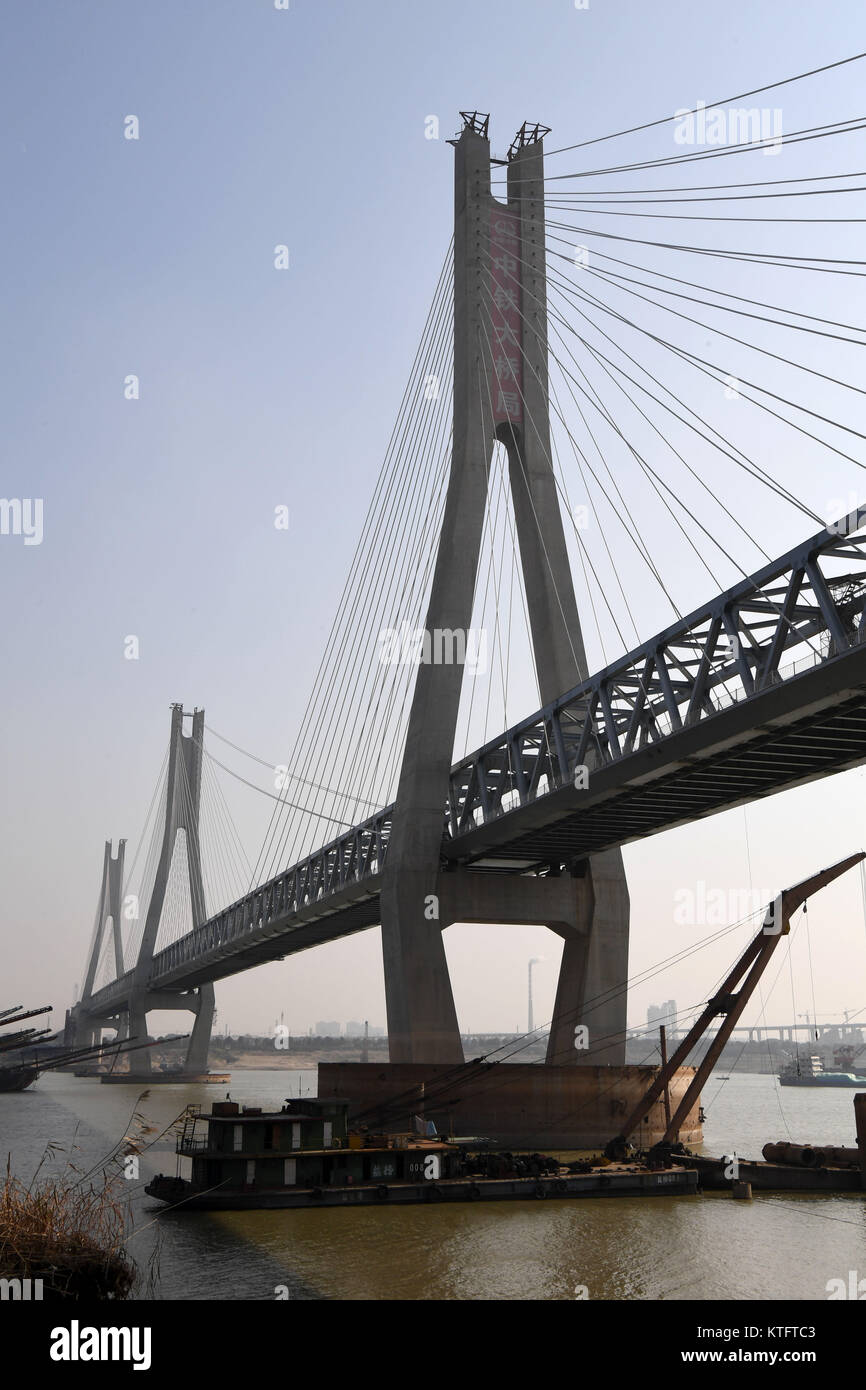 Yueyang. 24 dicembre, 2017. Foto scattata a Dic. 24, 2017 mostra il cantiere per la costruzione di una linea ferroviaria ponte sopra il lago Dongting, il secondo più grande lago d'acqua dolce in Cina, nella città di Yueyang, centrale provincia cinese di Hunan. I 1.290 metri di ponte è una parte importante della più lunga del mondo heavy-duty ferrovia per il trasporto di carbone. Il 1,837-km stazione è ancora in costruzione ed è progettato per collegare il carbone-ricca western Mongolia Interna Regione Autonoma con Ji'an City in Cina orientale della provincia di Jiangxi. La linea ferroviaria è prevista per il funzionamento in 2020. Credito: Zhu Xiang/Xinhua/Alamy Live News Foto Stock