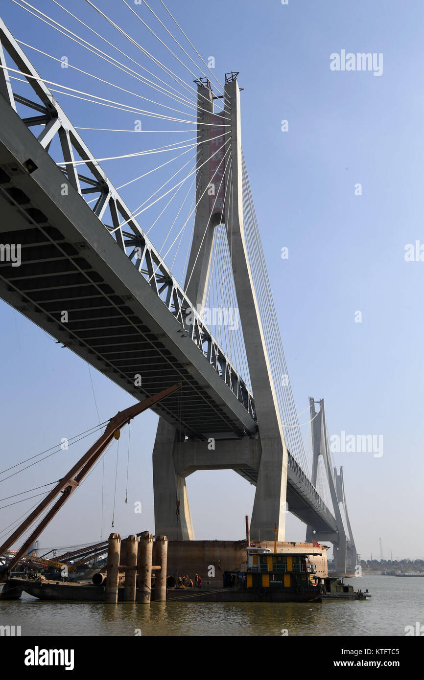 Yueyang. 24 dicembre, 2017. Foto scattata a Dic. 24, 2017 mostra il cantiere per la costruzione di una linea ferroviaria ponte sopra il lago Dongting, il secondo più grande lago d'acqua dolce in Cina, nella città di Yueyang, centrale provincia cinese di Hunan. I 1.290 metri di ponte è una parte importante della più lunga del mondo heavy-duty ferrovia per il trasporto di carbone. Il 1,837-km stazione è ancora in costruzione ed è progettato per collegare il carbone-ricca western Mongolia Interna Regione Autonoma con Ji'an City in Cina orientale della provincia di Jiangxi. La linea ferroviaria è prevista per il funzionamento in 2020. Credito: Zhu Xiang/Xinhua/Alamy Live News Foto Stock