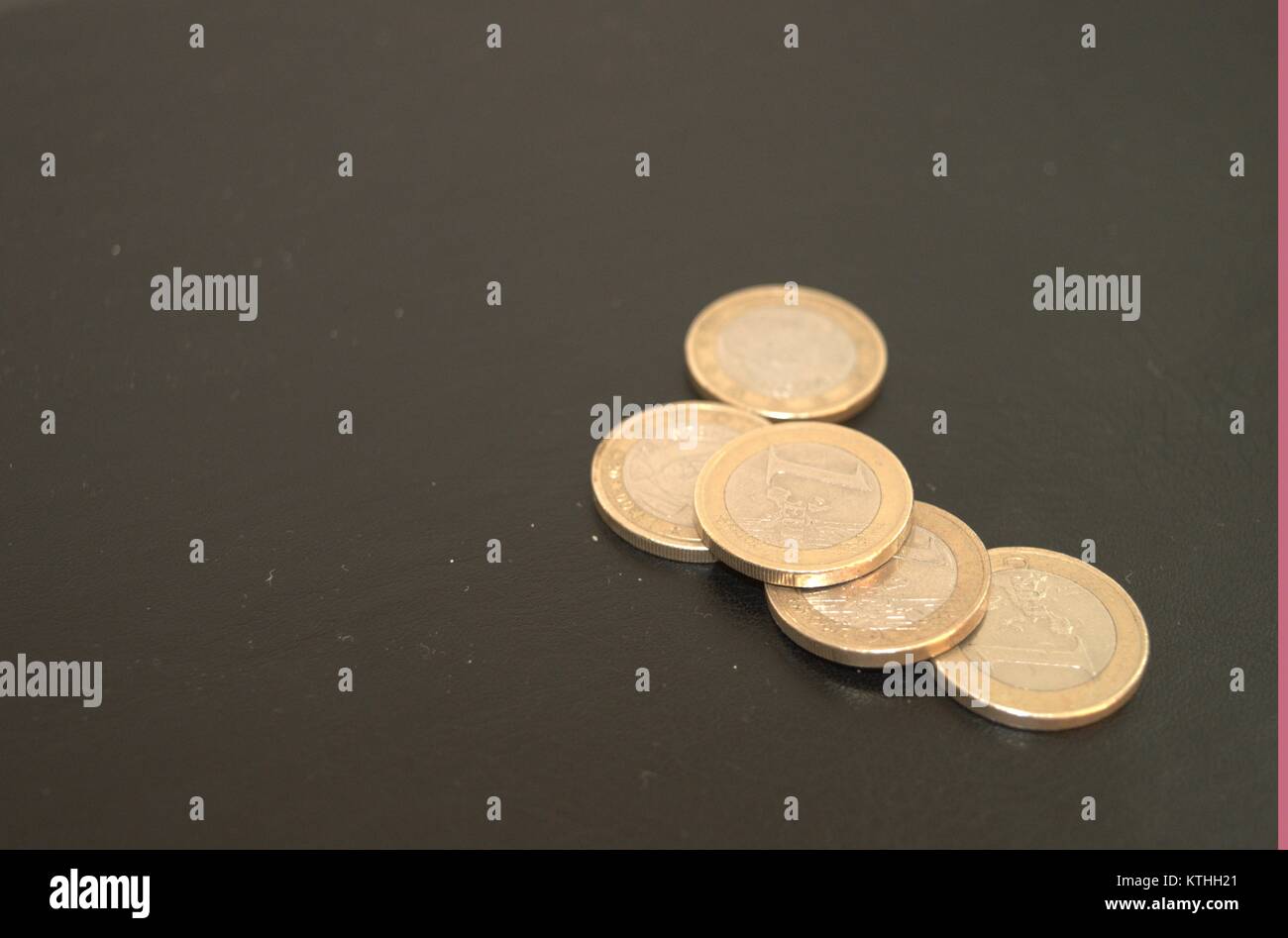 Alcune monete e monetine su sfondo scuro che dà alle persone l'idea di risparmiare denaro in cattiva situazione economica.prendere cura di un centesimo. Foto Stock