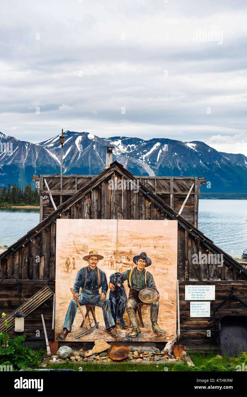 Un murale di due minatori d'oro nel piccolo e sperduto villaggio di Atlin nel nord della British Columbia, Canada Foto Stock