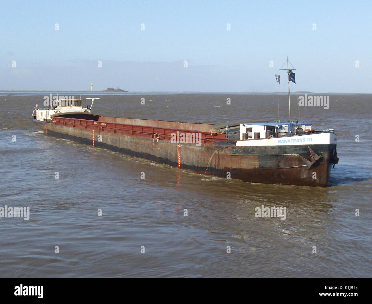 La Barge Nawatrans III è una nave da carico utilizzata per il trasporto di merci. Questa nave svolge un ruolo chiave nel settore della logistica e dei trasporti, operando su vie navigabili per consegnare le merci in modo efficiente. Il suo design è ottimizzato per il trasporto di carichi e la navigazione su stretti corsi d'acqua. Foto Stock