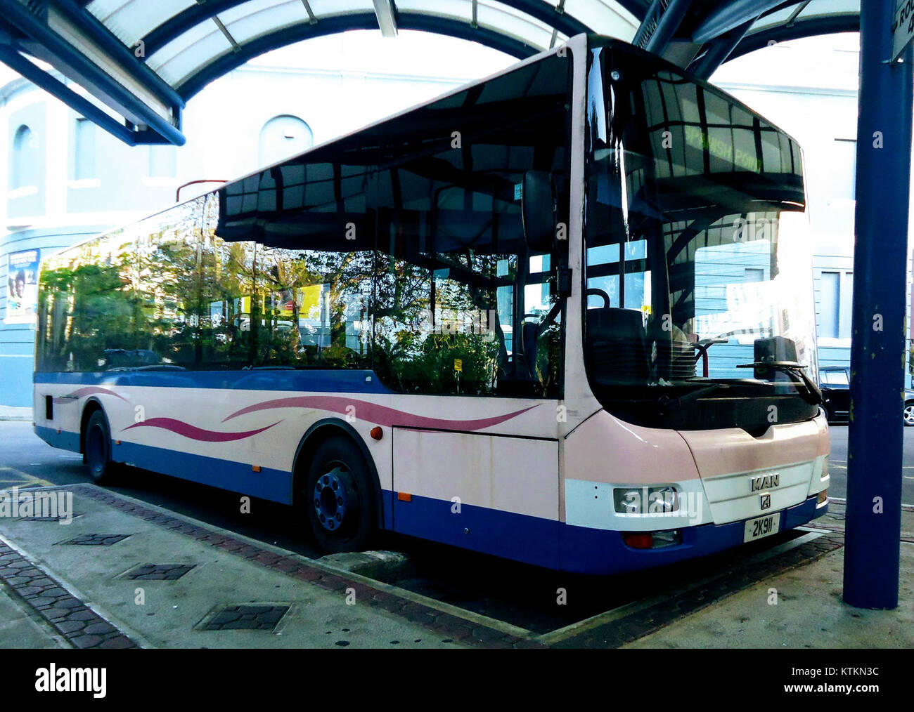 Questa immagine mostra un autobus parcheggiato alla stazione degli autobus di Hamilton a Bermuda, un territorio britannico d'oltremare. L'autobus fa parte del sistema di trasporto pubblico dell'isola, fornendo il trasporto all'interno della capitale. Foto Stock