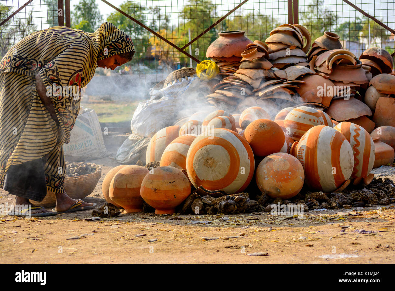 Una donna potter disponendo pentole per la cottura Foto Stock