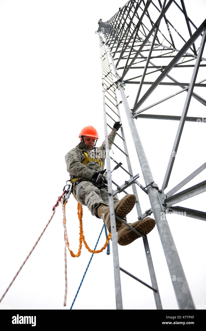 Stati Uniti Air Force Tech. Sgt. Michael Griepsma inizia alla sommità di un 85 ft. torre di comunicazione a gamma Adirondack, Ft. Tamburo NY il 22 Nov 2011. Le torri sono utilizzate per tenere la telecamera per visualizzare gli obiettivi di gamma verso il basso. (U.S. Air Force foto di TSgt Ricky migliori) Foto Stock