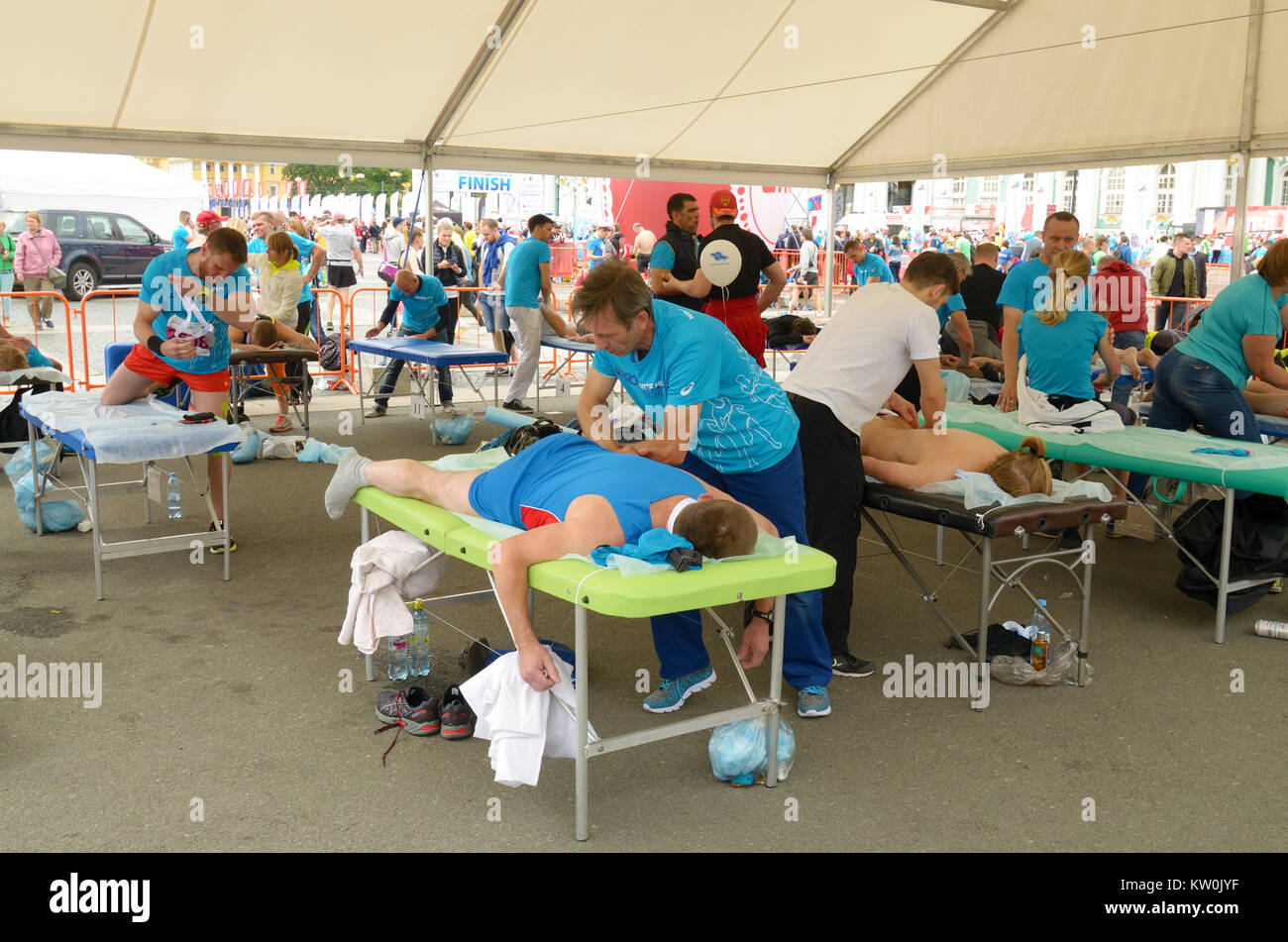 09.07.2017.Russia.San Pietroburgo.Sport massaggi terapeuti aiutare gli atleti dopo una gara di maratona. Foto Stock