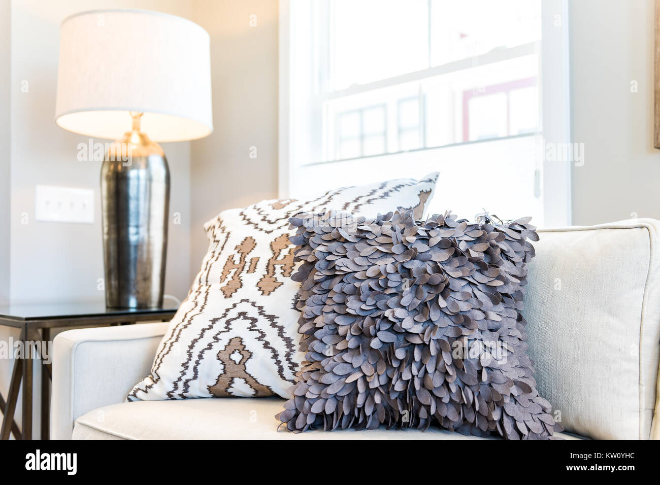 Primo piano di due cuscini sul lettino o divano dalla finestra luminosa in  moderno appartamento, casa o casa con allestimento di grandi beige, bianco  neutro colori, lampada Foto stock - Alamy