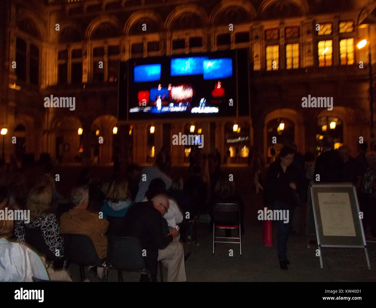 Un grande schermo collocato all'esterno dell'Opera di Vienna fornisce una piattaforma per mostrare spettacoli dal vivo e trasmissioni. Posizionato di fronte al teatro dell'opera, consente ai passanti di godersi l'opera e gli eventi culturali, creando un'esperienza visiva pubblica. Lo schermo contribuisce all'accessibilità dell'alta cultura, rendendo gli spettacoli disponibili a un pubblico più ampio a Vienna. Foto Stock