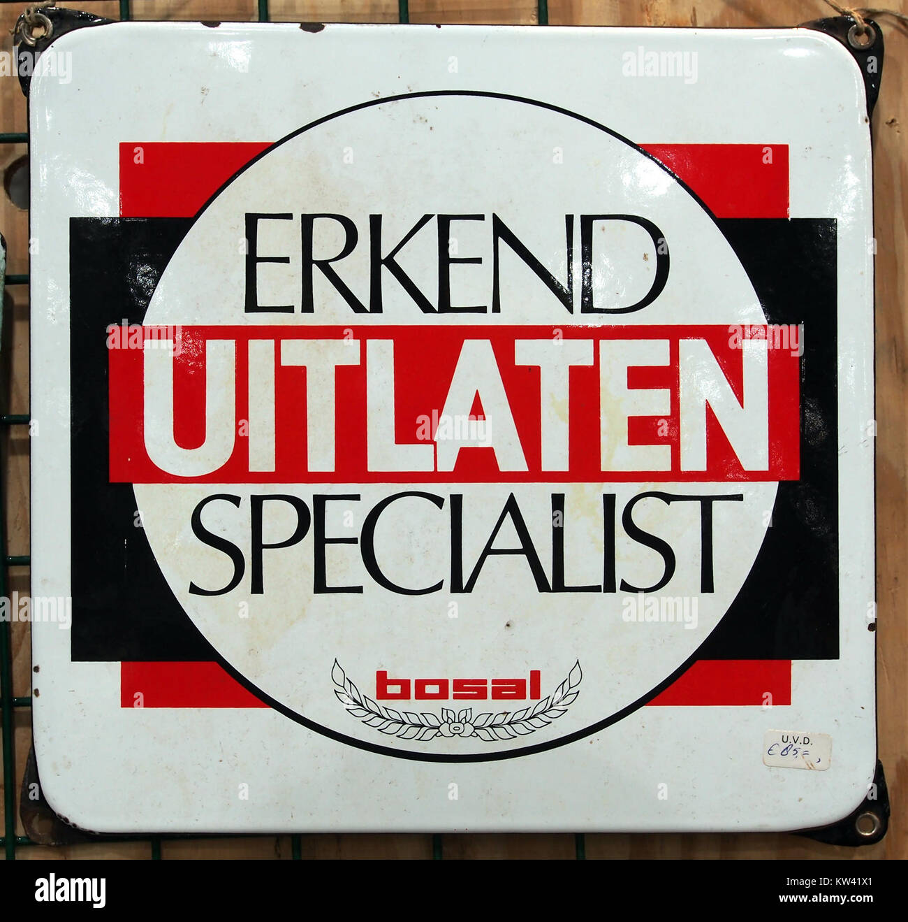Un cartello pubblicitario in smalto di Boasl Uitlaten Specialist, un'azienda probabilmente coinvolta nei sistemi di scarico dei veicoli, caratterizzato da un design vintage popolare nel commercio europeo della metà del XX secolo. Foto Stock