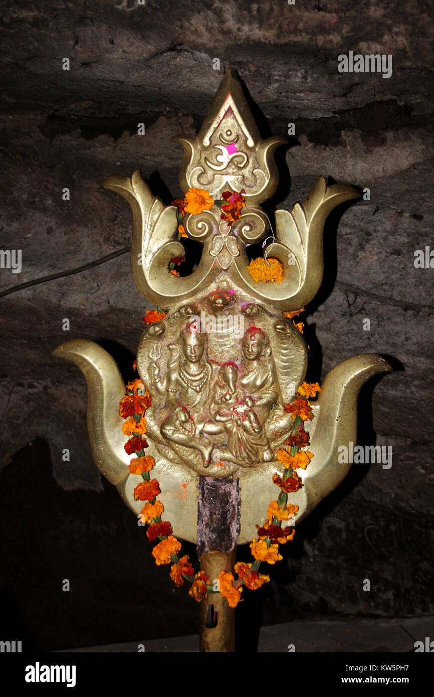 Fase tripla trishul (Trident) con immagine incisa di Shiva e Parvathi a Jata Shankar grotta in Pachmarhi, Madhya Pradesh, India, Asia Foto Stock