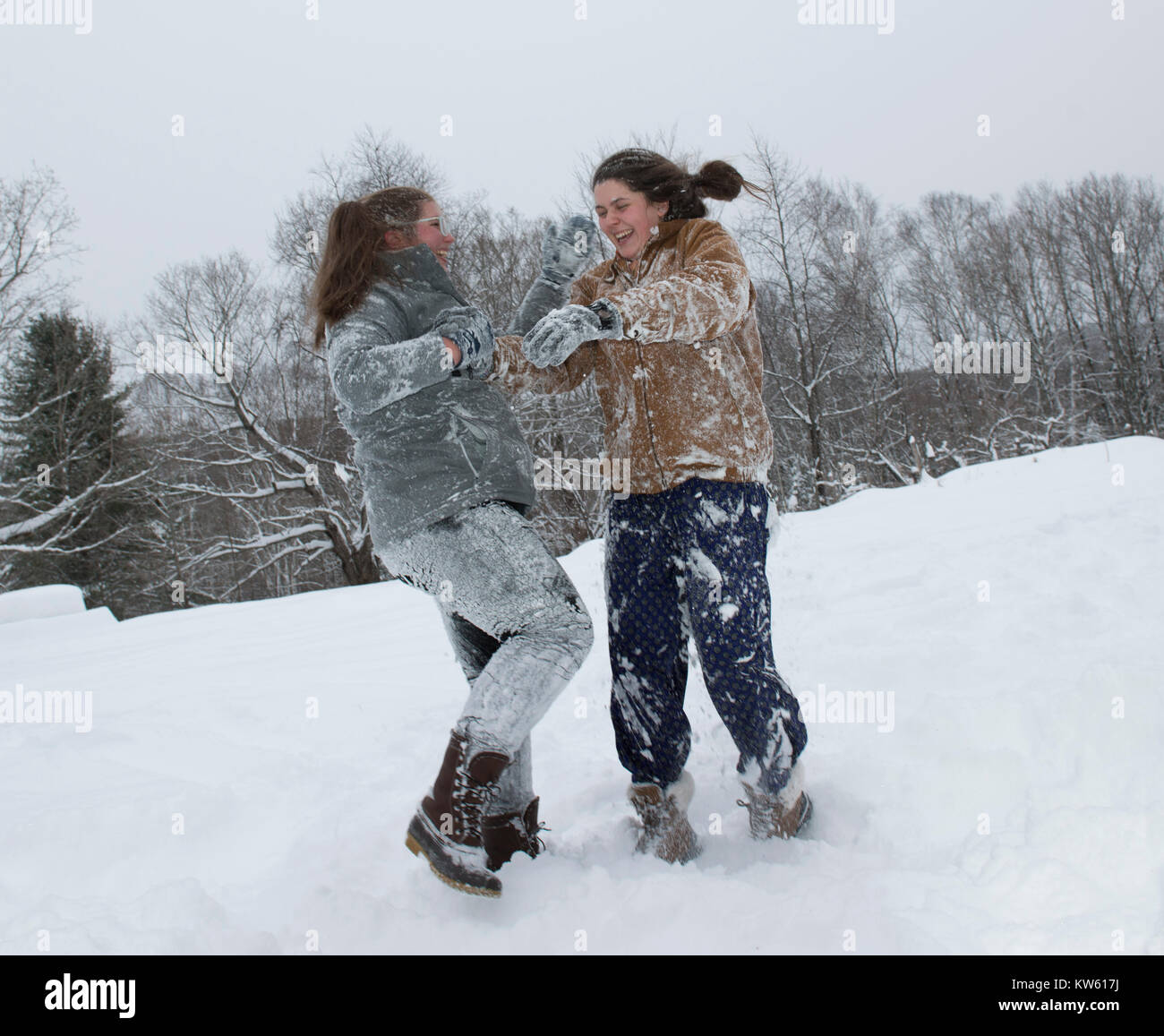 Sorelle Eliza, 26, sinistra e Georgia Doolittle, 17 hanno una lotta a palle di neve nel Maine Foto Stock