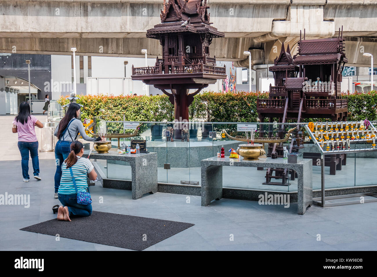 I thailandesi in ginocchio a pregare in pubblico Foto Stock