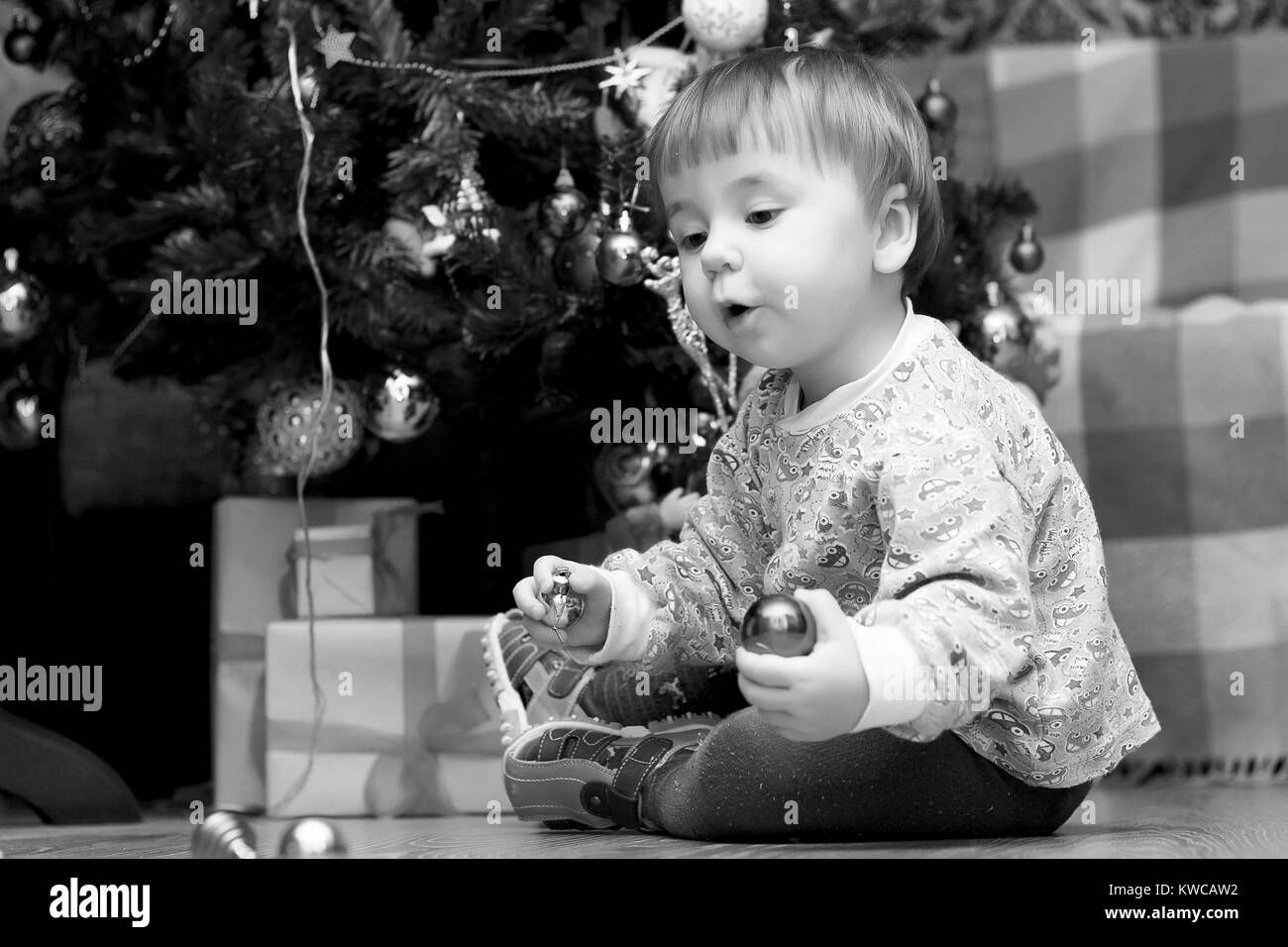 I bambini piccoli nei pressi di un albero di Natale prima delle vacanze Foto Stock