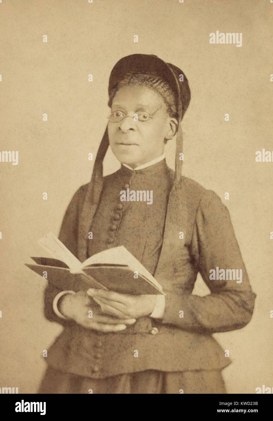 Ritratto di un Africano donna americana, indossa gli occhiali, e poste con Libro, c. 1880-1900. La fotografia è stata fatta da Bostwick il cui indirizzo è stato 98 Sesta Avenue, New York City (BSLOC 2017 20 117) Foto Stock