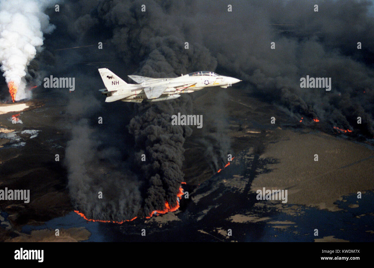 1991 olio kuwaitiani incendi, U.S. Navy Grumman F-14A Tomcat vola sopra un olio ben impostata istoriati da parte delle truppe irachene durante la guerra del Golfo del 1991. Foto Stock