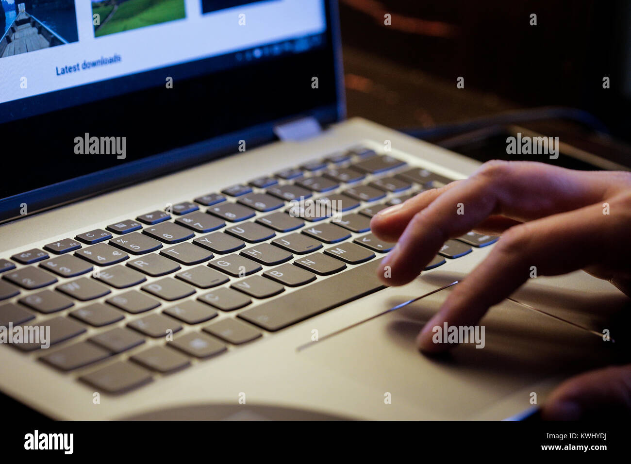Giovane uomo utilizza laptop a elettronicamente il pagamento delle fatture con la sua carta di credito Foto Stock