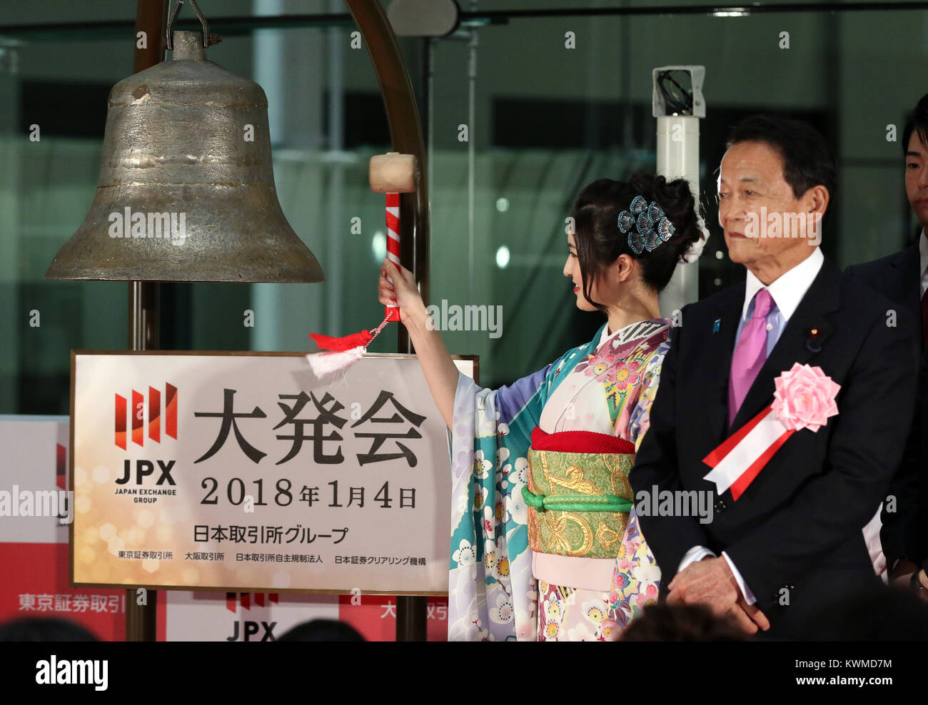 Tokyo, Giappone. 4 gennaio, 2018. Una donna in kimono suona il campanello mentre il Ministro delle finanze giapponese Taro Aso (R) si affaccia su durante una cerimonia organizzata per celebrare il primo giorno di negoziazione del 2018 presso la Borsa di Tokyo giovedì 4 gennaio, 2018. La quota del Giappone è prezzi saltato 561.12 yen per chiudere a 23,326.06 yen presso la sessione mattutina della Borsa di Tokyo. Credito: Yoshio Tsunoda/AFLO/Alamy Live News Foto Stock
