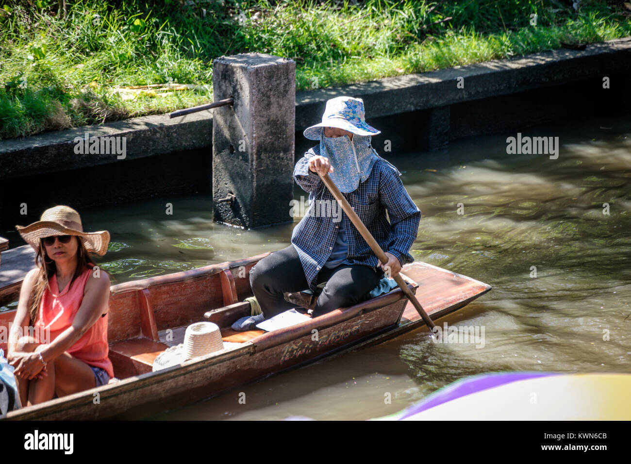 Thai paddling barca con i turisti sul fiume, Damnoen Saduk mercato galleggiante, Thailandia. Foto Stock