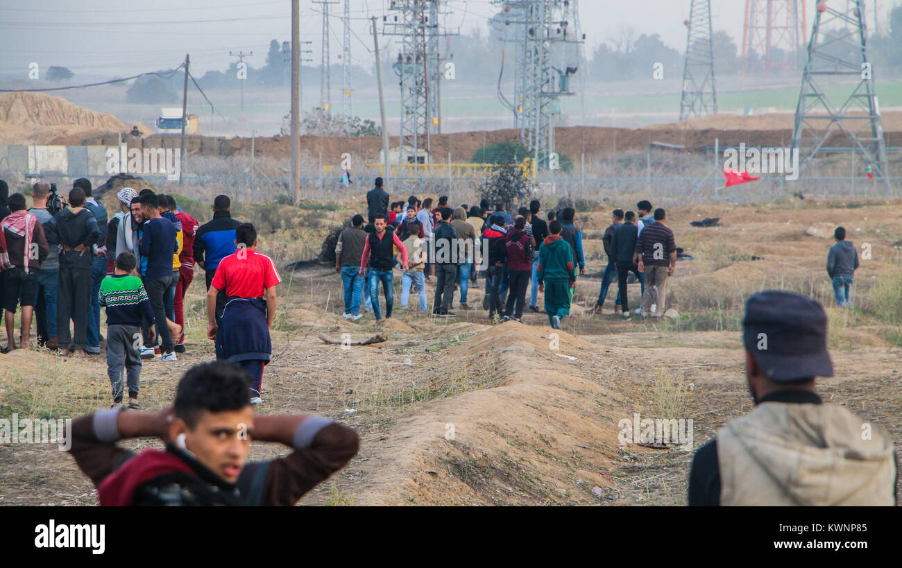 Un gruppo di giovani palestinesi nella striscia di Gaza si alzano in piedi davanti al recinto di separazione con Israele Solidarietà con Gerusalemme contro Trump per la decisione di dichiarare Foto Stock