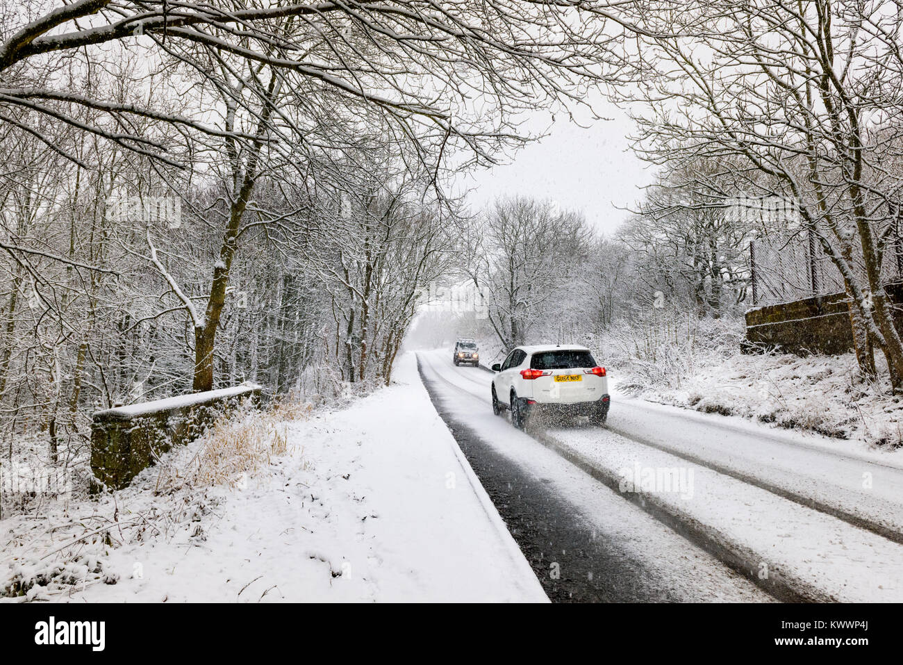 Coperta di neve strada nella campagna inglese e in inverno. Vetture navigare snowy strada rurale della contea di Durham in invernale condizioni motoristica in Inghilterra Settentrionale Foto Stock