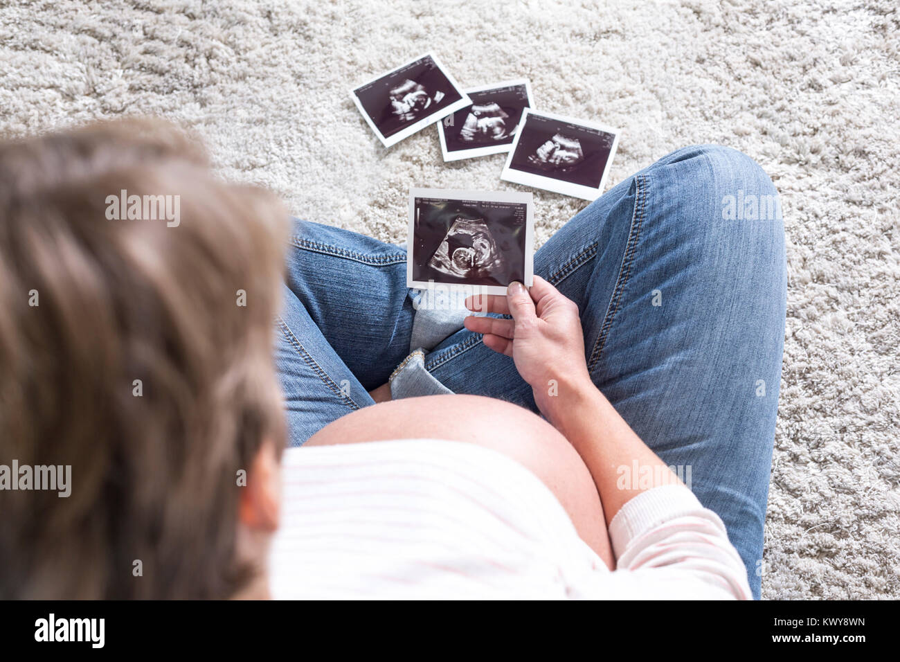 Schwanger Frau betrachtet Ultraschallbilder Foto Stock