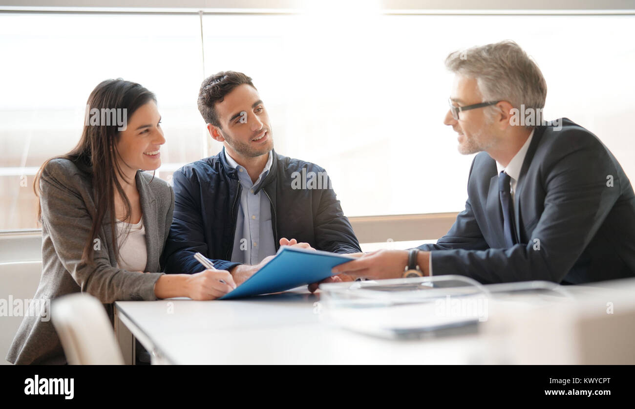 Coppia giovane incontro di advisor finanziario per investimento iniziale Foto Stock