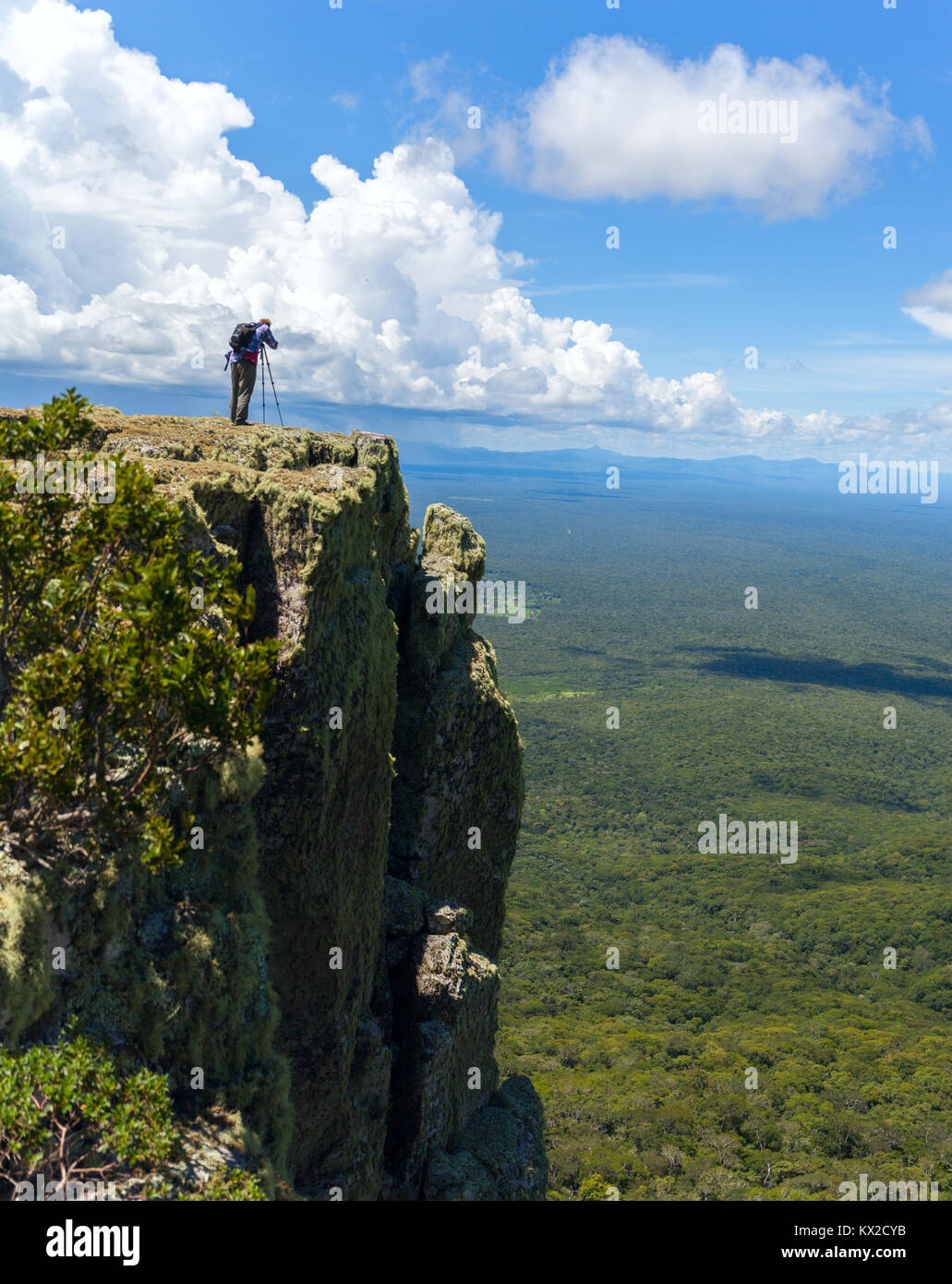Wildlife Photographer sul vertice di montagna di fotografare il tramonto nel paesaggio e cielo blu Foto Stock