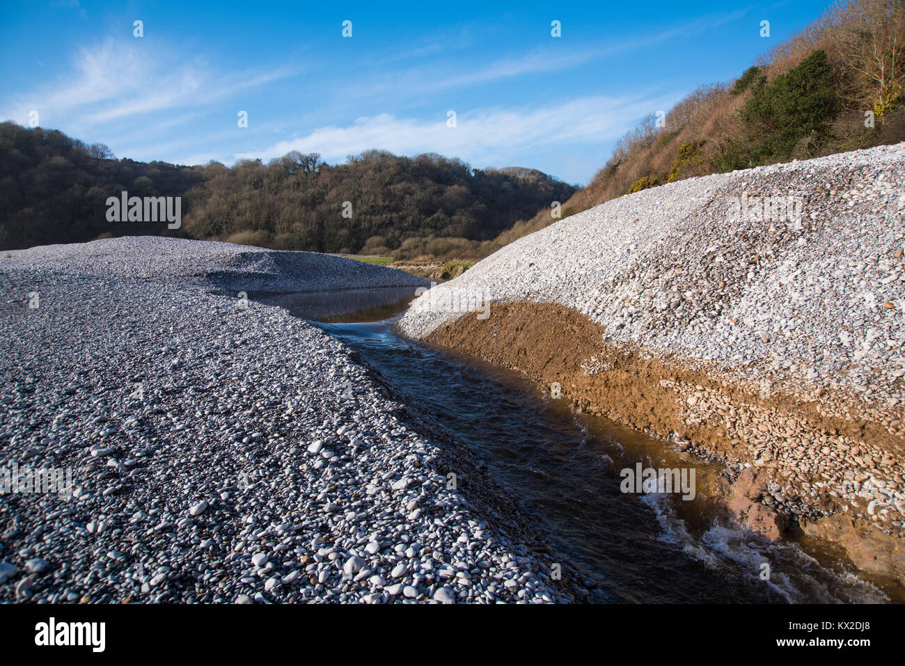 Bishopston Valley Stream che scorre attraverso la profonda spiaggia di pietra a Pwlldu Bay, Gower, South Wales, Regno Unito. Foto Stock