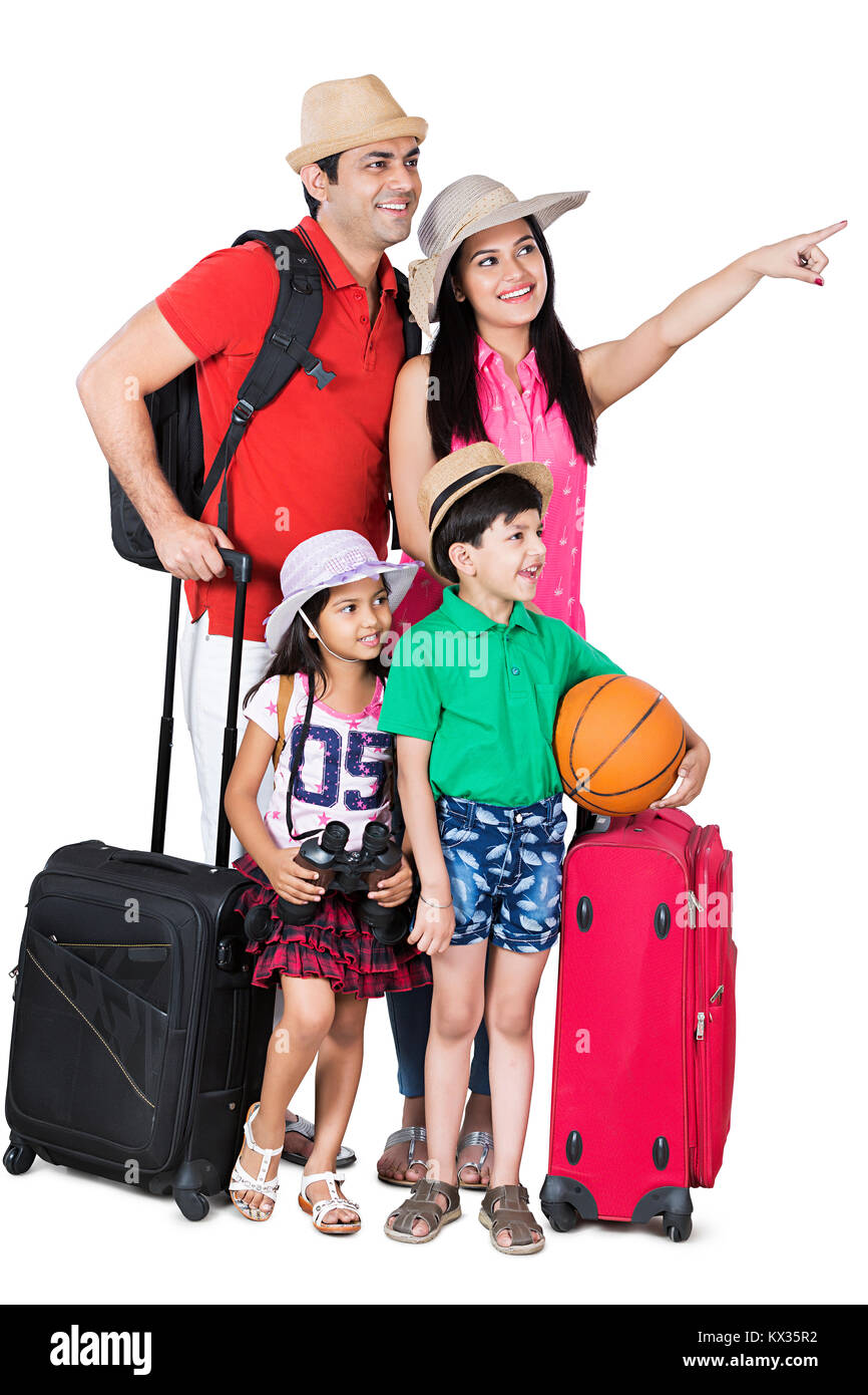 La famiglia felice con i bagagli puntare il dito che mostra pronto a Vacation-Holiday Foto Stock