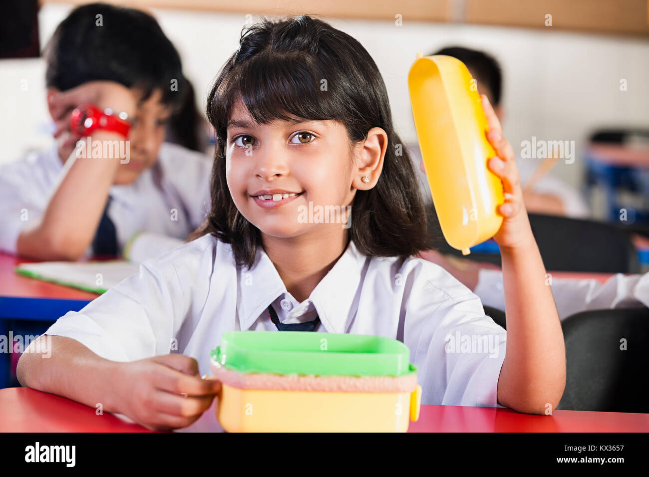 1 Indian School girl pausa pranzo a mangiare il pranzo in aula Foto Stock