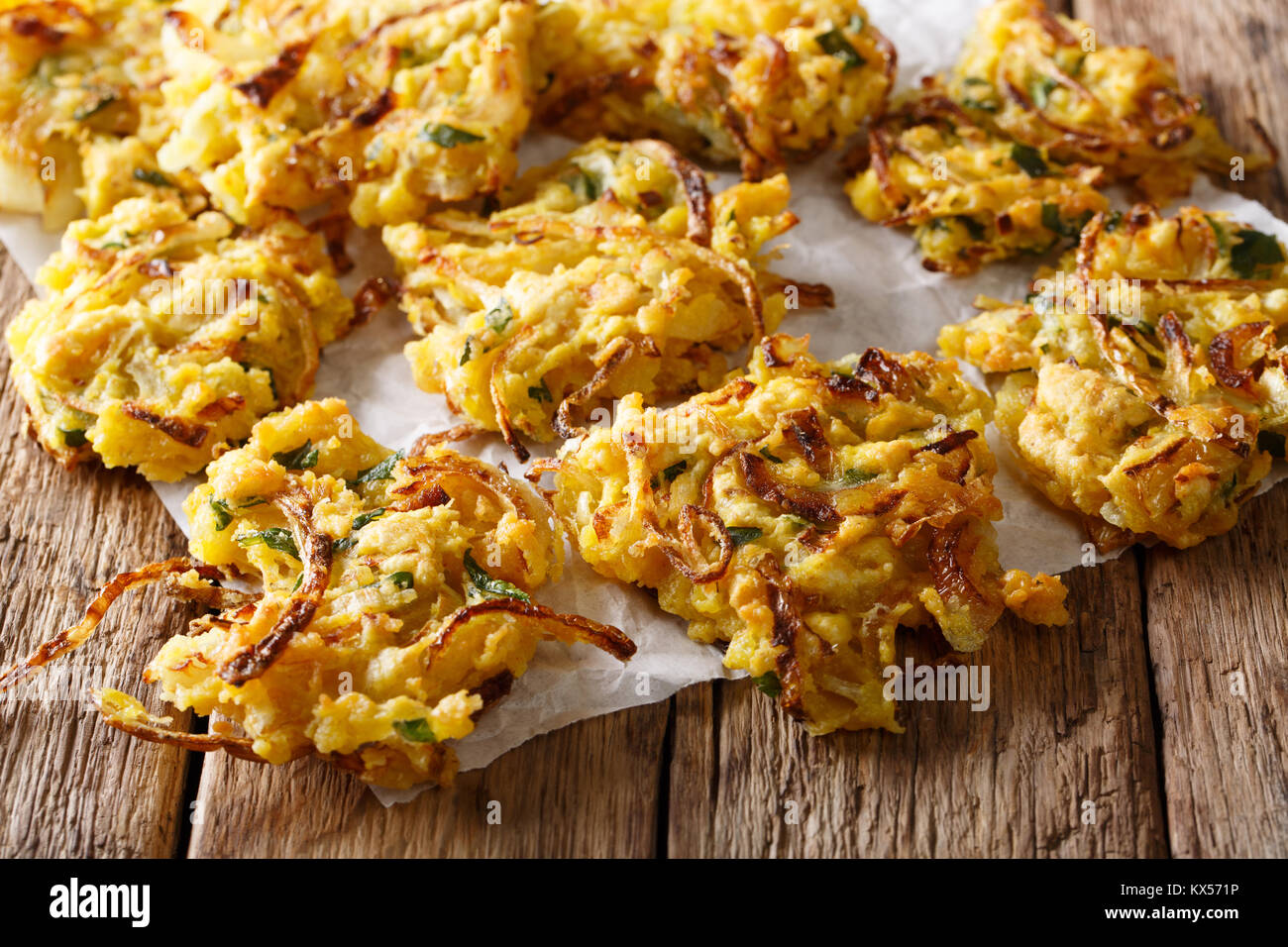 Il cibo indiano: croccante di cipolla fritti Bhajis vicino sul tavolo orizzontale. Foto Stock