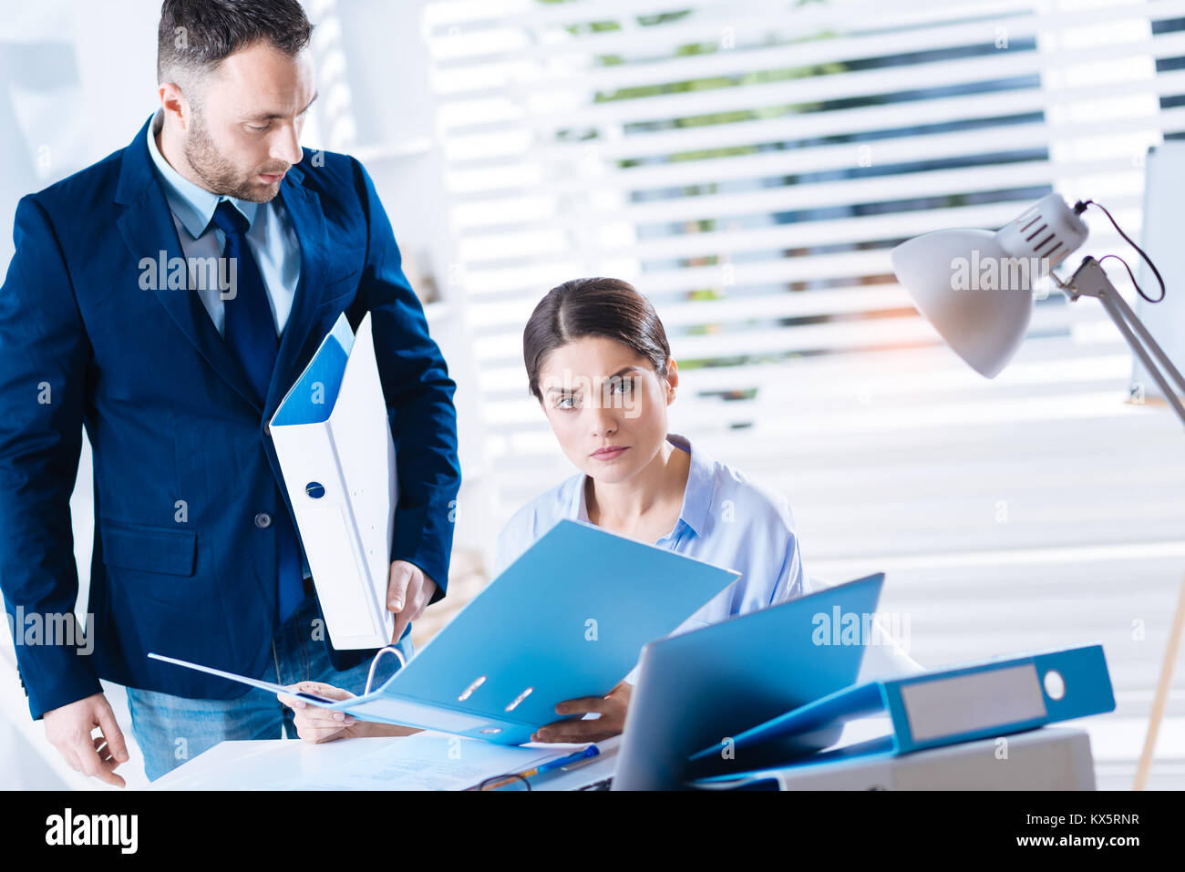 Strict donna in possesso di una cartella e cercando insoddisfatto Foto Stock