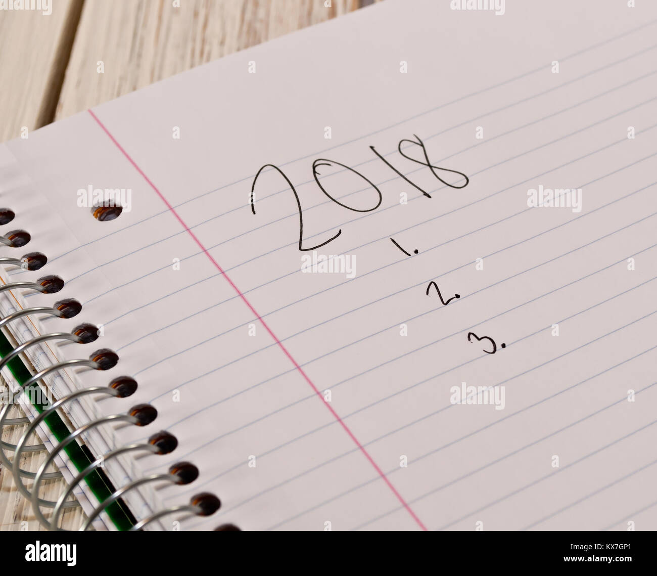 2018 Elenco impegni scritti su un notebook bianco in inchiostro nero con il notebook posa su un bianco tavolo in legno Foto Stock