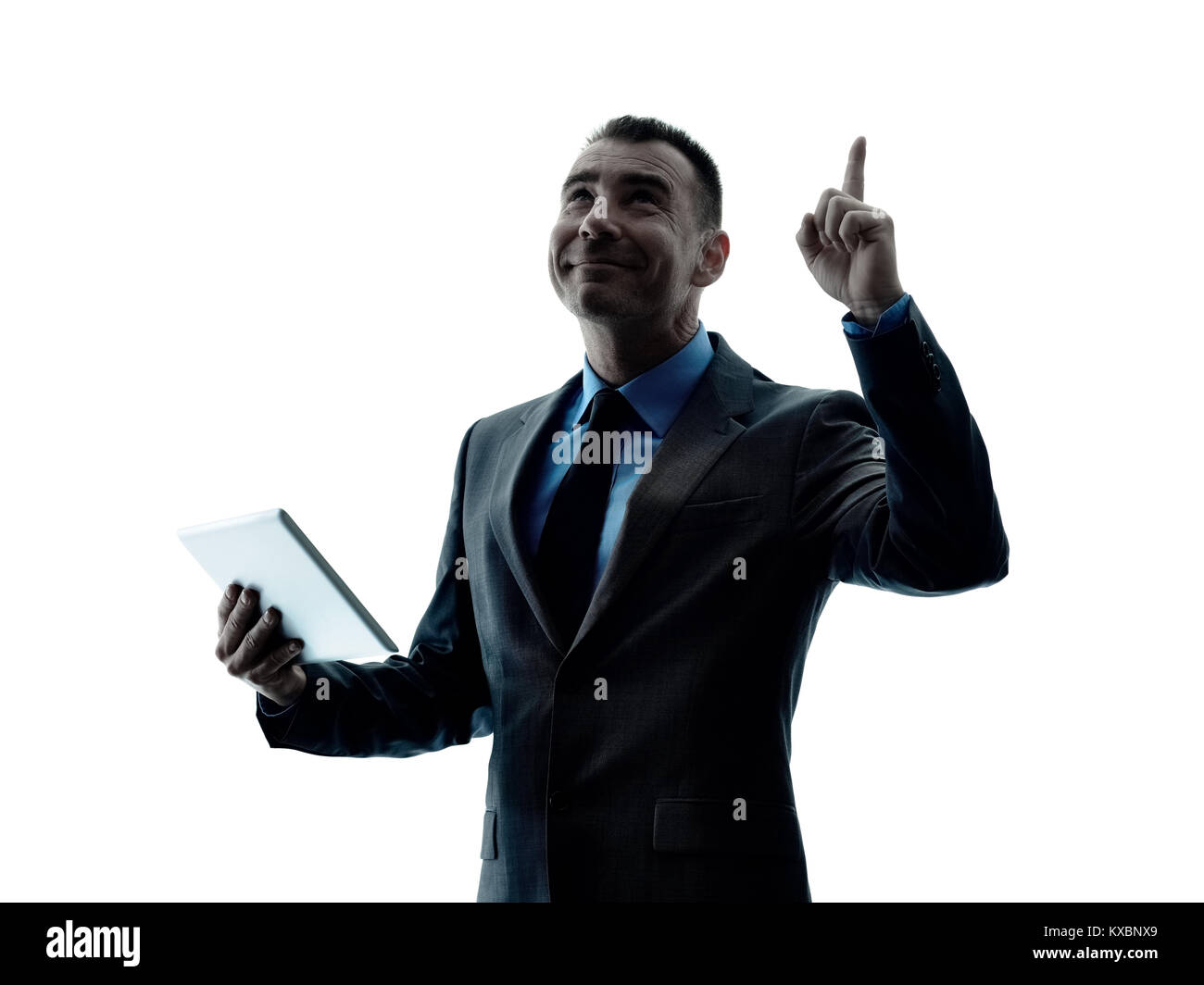 Un caucasian business man standing con tavoletta digitale silhouette isolati su sfondo bianco Foto Stock