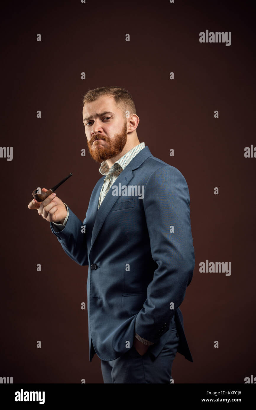 Uomo elegante con la barba tenuta tubo di fumo Foto Stock