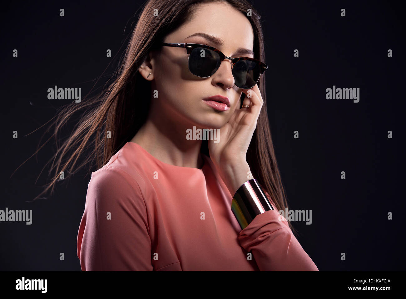 Bella giovane donna in occhiali da sole guardando la fotocamera Foto Stock