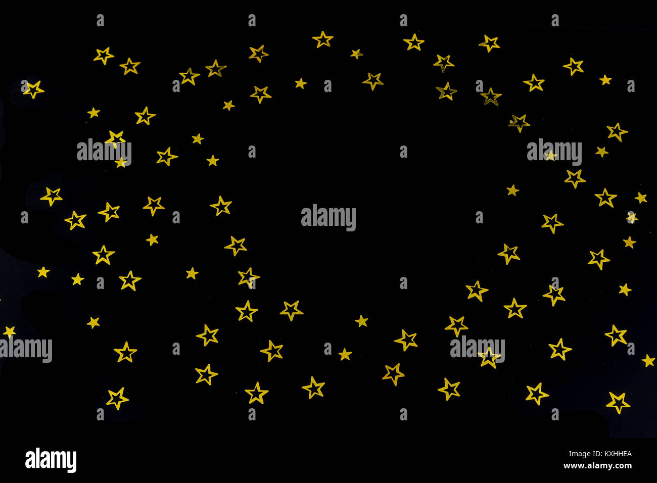 Sfondo di golden particelle glitter stelle su sfondo nero,felice con copia spazio su medio Foto Stock