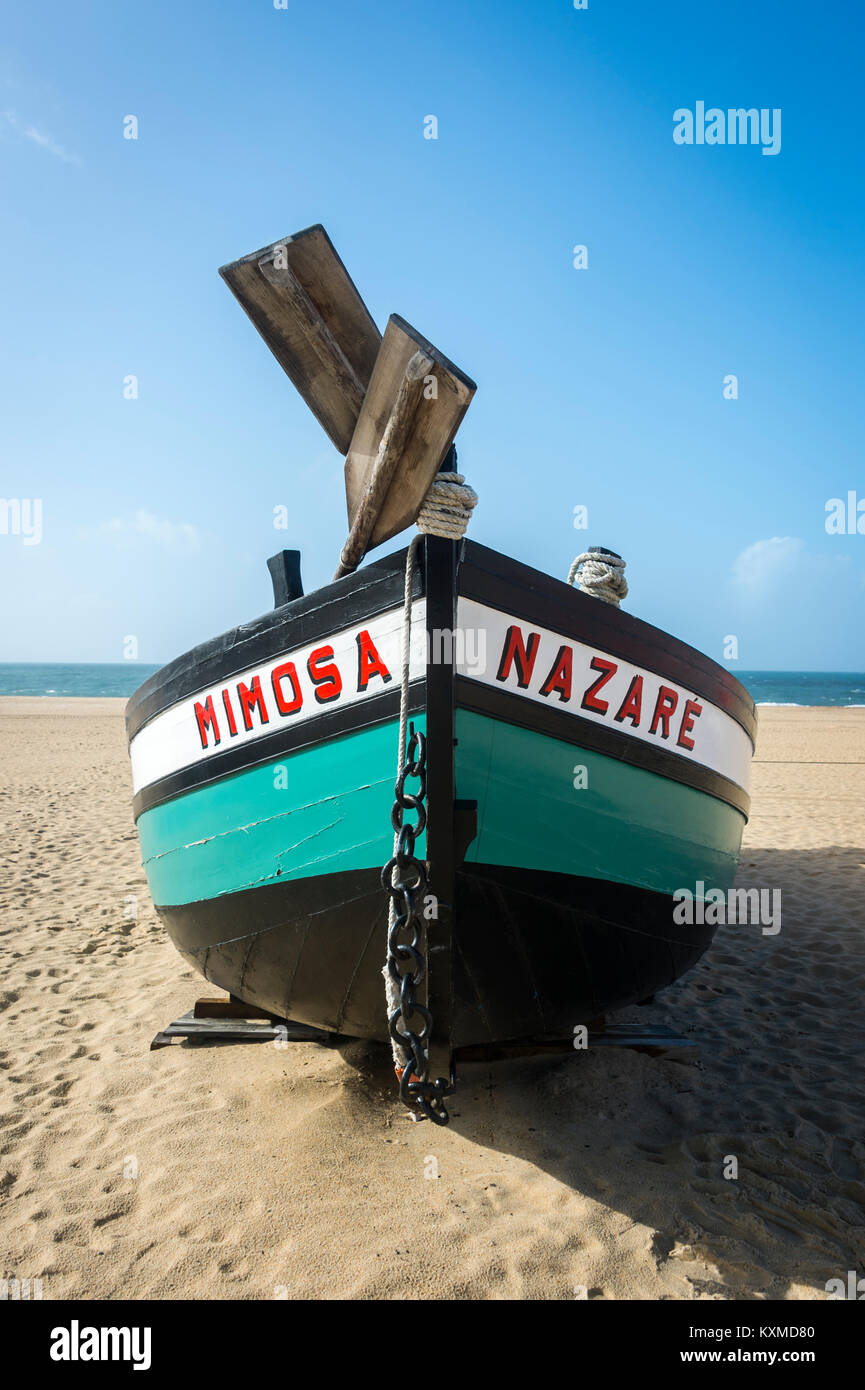Tradizionale verde e nero dipinto barche da pesca 'Mimosa' sulla riva a Nazare, Portogallo Foto Stock