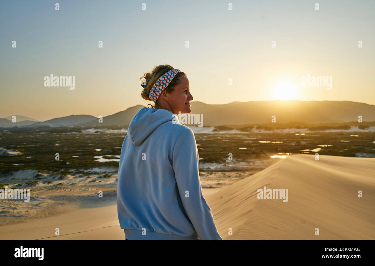 Donna che guarda lontano al tramonto su dunes,Florianopolis,Santa Catarina, Brasile,l America del Sud Foto Stock