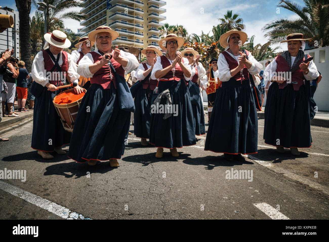 Puerto de la Cruz Tenerife Isole Canarie - Maggio 30, 2017: Canarie persone vestite con abiti tradizionali a piedi lungo la strada, segno e riproduzione di musica Foto Stock