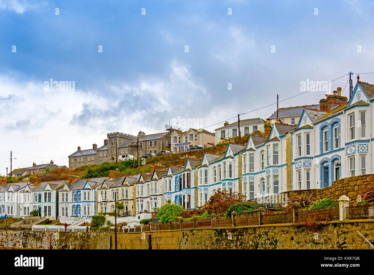 Una fila di distintivo case a schiera si affaccia sul porto di Porthleven sulla costa meridionale della Cornovaglia, England, Regno Unito Foto Stock