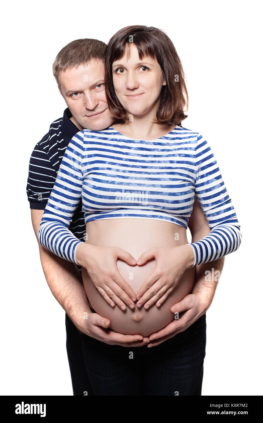 Coppia Uomo e donna fare un cuore sul ventre della donna incinta isolati su sfondo bianco Foto Stock