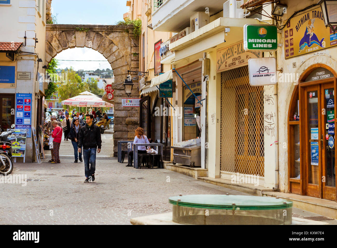 Rethymno, Grecia - 3 Maggio 2016: attrazione turistica Porta Guora. I turisti a camminare per le strade della città vecchia. Strada cartello pubblicitario su touristic Foto Stock
