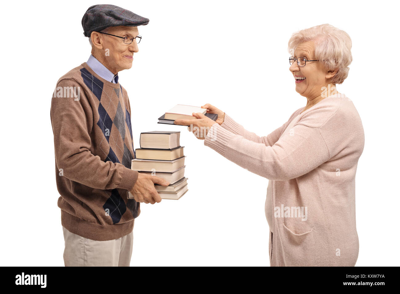 Donna anziana dando ai libri di un anziano uomo isolato su sfondo bianco Foto Stock