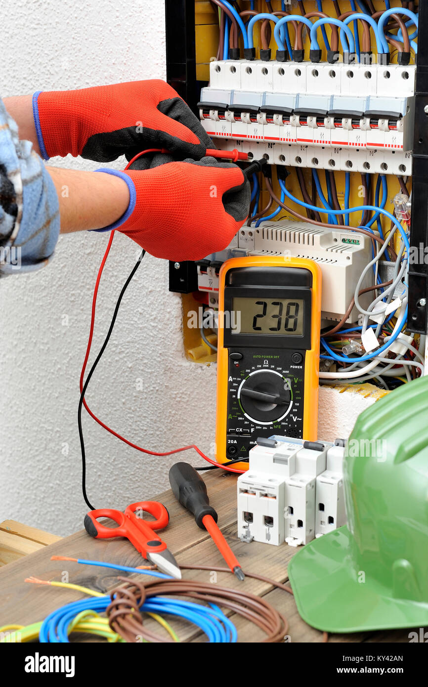 Giovane tecnico elettricista misure con un multimetro la tensione in un  quadro elettrico Foto stock - Alamy