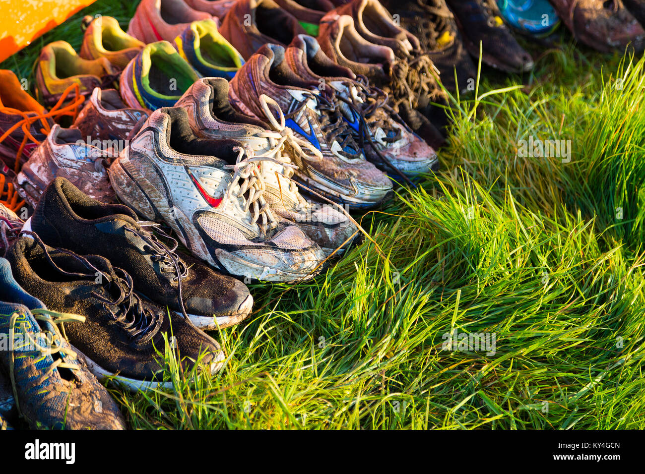 Sussex, Regno Unito. Scarpe abbandonate giacciono sull'erba dopo una dura Mudder evento. Foto Stock