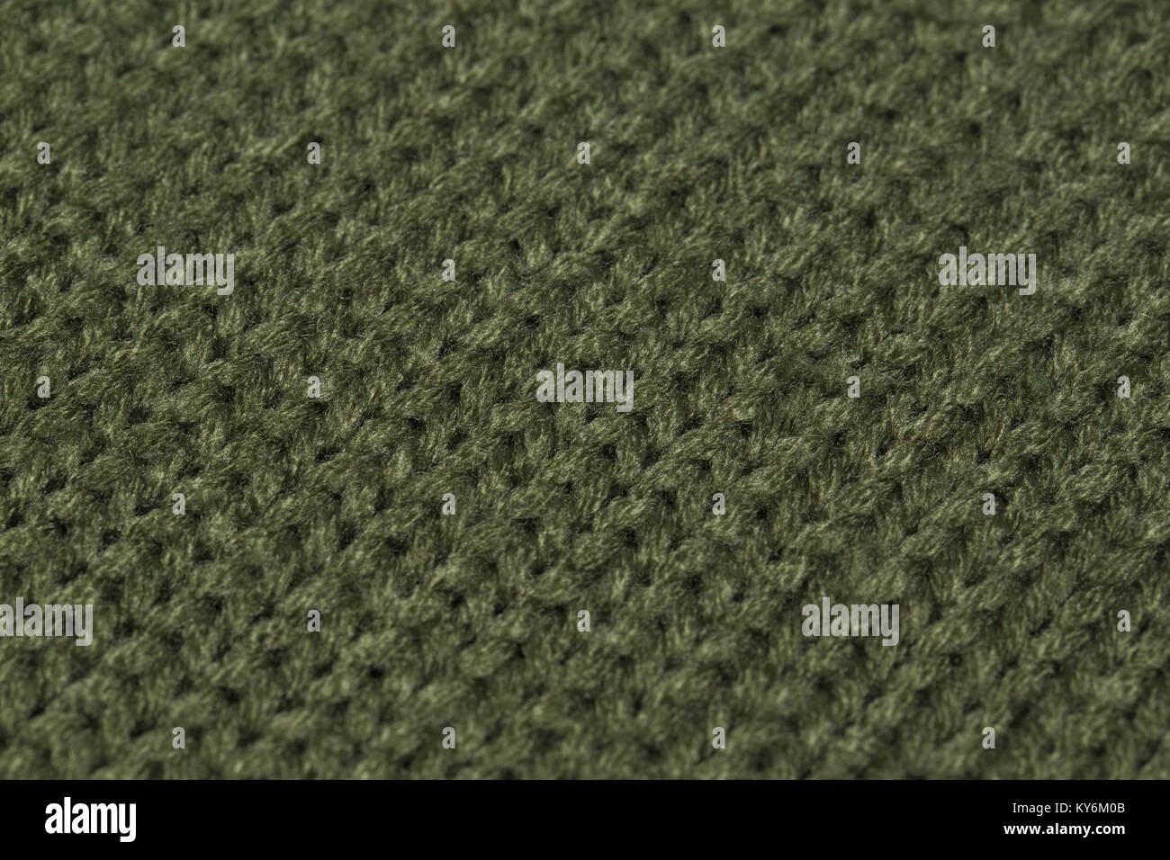 Macro immagine di colore verde di tessitura a maglia. Foto Stock
