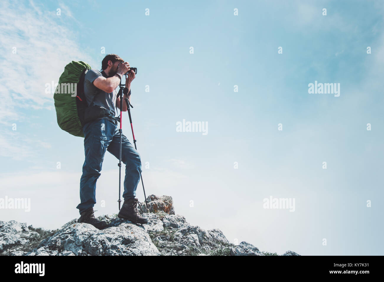 L'uomo fotografo con grande zaino e tenendo la fotocamera Foto di montagne stile di vita viaggio concetto hobby avventura vacanze di escursioni outdoor Foto Stock